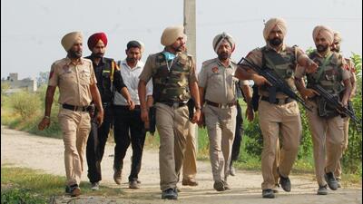 Punjab Police personnel standing guard at Hoshiar Nagar village in Amritsar on Wednesday. (Sameer Sehgal/HT)