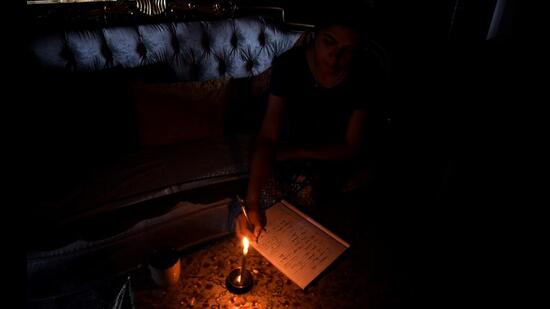 A girl studying with the help of candle light in Kharghar on Wednesday. The residents in some parts of Kharghar had to endure power outage for nearly 14 hours. BACHCHAN KUMAR/HT PHOTO (BACHCHAN KUMAR/HT PHOTO) A girl studying with the help of candle light in Kharghar on Wednesday. The residents in some parts of Kharghar had to endure power outage for nearly 14 hours. BACHCHAN KUMAR/HT PHOTO (BACHCHAN KUMAR/HT PHOTO)