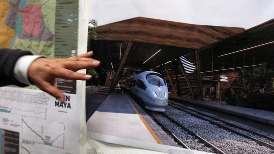 Rogelio Jiménez Pons, director of Fonatur, points to photos of a planned train through the Yucatan Peninsula, during an interview in Mexico City. The Mexican government invoked national-security powers to forge ahead with the tourist train along the Caribbean coast &nbsp;(AP Photo/Marco Ugarte, File)