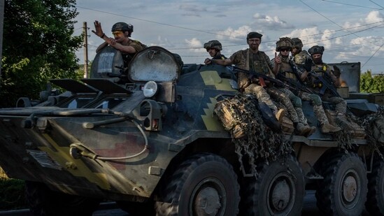 Ukrainian soldiers ride a tank, on a road in Donetsk region, eastern Ukraine, Wednesday.(AP)