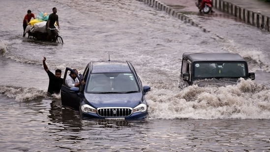 Vehicles wade through a heavily waterlogged stretch at NH24 near Mayur Vihar after heavy rain in New Delhi, India, on Wednesday, July 20, 2022. (Photo by Raj K Raj/Hindustan Times)