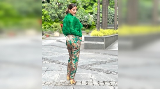 Hina Khan shows how to ace the formal look in a green solid top featuring a collar belt and printed high-rise trousers.(Instagram/@realhinakhan)