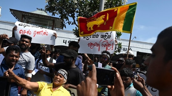 Demonstrators shout slogans against interim Sri Lankan President Ranil Wickremesinghe during a protest in front of the Fort railway station in Colombo. (Photo by Arun SANKAR/AFP)