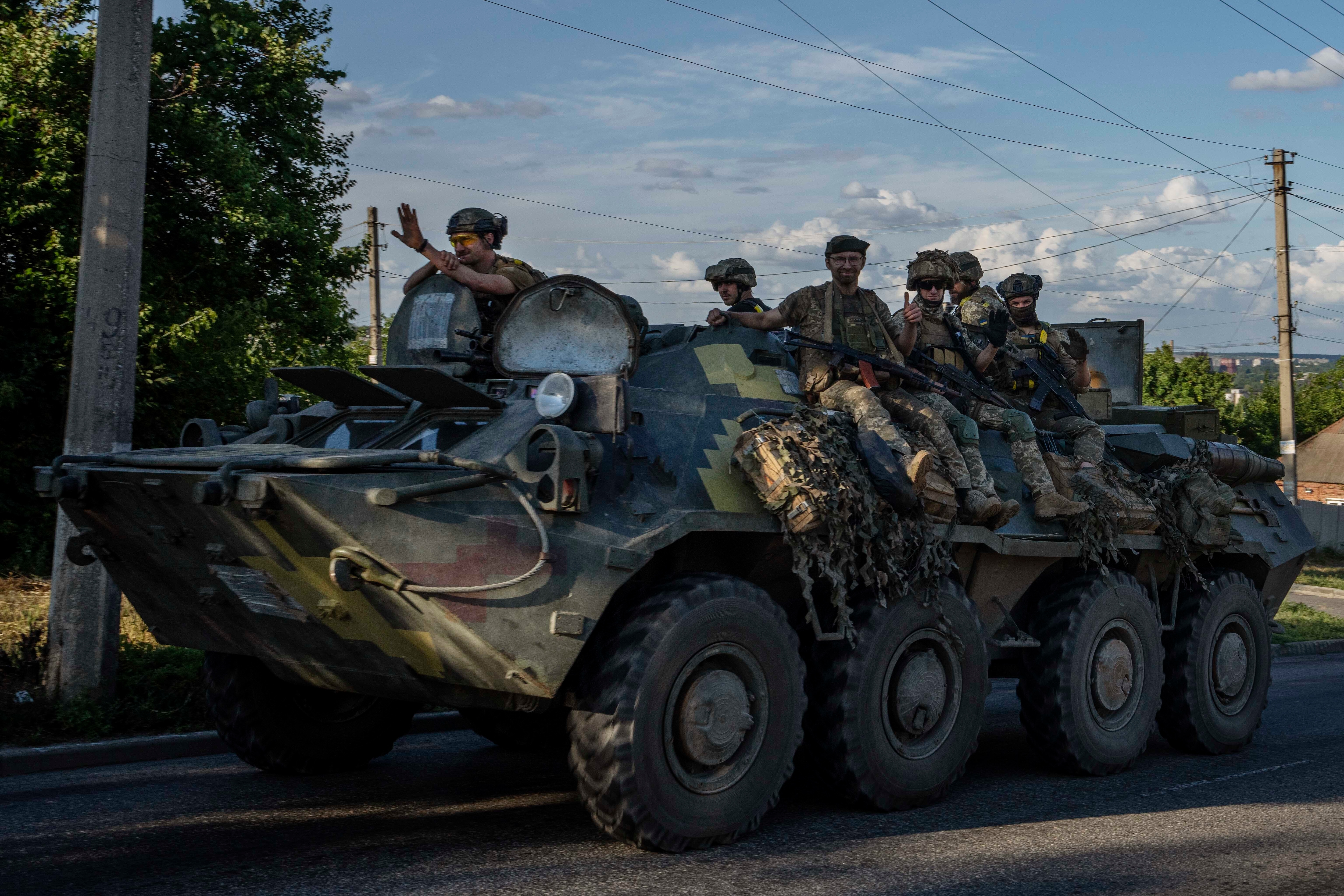 Ukrainian soldiers ride a tank, on a road in Donetsk region, eastern Ukraine, Wednesday. (AP) Ukrainian soldiers ride a tank, on a road in Donetsk region, eastern Ukraine, Wednesday. (AP)