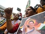 Congress activists shout slogans and hold placards inside the All India Congress Committee office during a protest against the questioning by ED of Sonia Gandhi in New Delhi.(AFP) Congress activists shout slogans and hold placards inside the All India Congress Committee office during a protest against the questioning by ED of Sonia Gandhi in New Delhi.(AFP)
