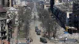 Military vehicles of pro-Russian troops drive along a street during Ukraine-Russia conflict in the southern port city of Mariupol.&nbsp;