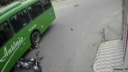 A biker escaped death even after coming head-first under a bus wheel on Monday. (Image source: Screenshot of Twitter video)