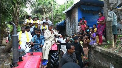 Telugu Desam Party president N Chandrababu Naidu in a flood-affected area in Andhra Pradesh on Thursday. (HT Photo)