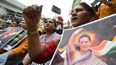 Congress activists shout slogans and hold placards inside the All India Congress Committee office during a protest against the questioning by ED of Sonia Gandhi in New Delhi. (AFP) Congress activists shout slogans and hold placards inside the All India Congress Committee office during a protest against the questioning by ED of Sonia Gandhi in New Delhi. (AFP)