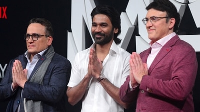 American movie directors and producers Joe Russo and his brother Anthony Russo with Dhanush (centre) at the screening of The Gray Man in Mumbai. (AFP) (AFP)