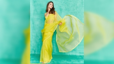 Vaani Kapoor teamed her solid yellow saree featuring a thin embroidered border with a sleeveless bralette blouse. (Instagram/@_vaanikapoor_)