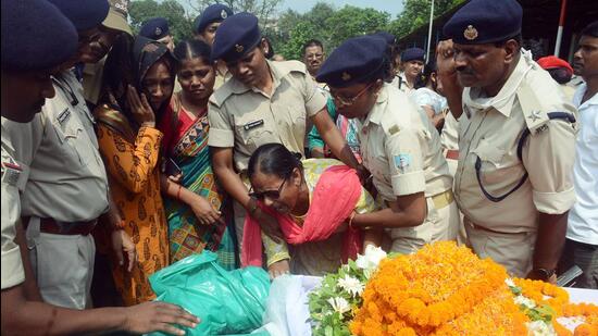 Family member of Jharkhand Police sub-inspector Sandhya Topno, who was mowed down during a vehicle check, mourn near her mortal remains, in Ranchi on Wednesday. (ANI) Family member of Jharkhand Police sub-inspector Sandhya Topno, who was mowed down during a vehicle check, mourn near her mortal remains, in Ranchi on Wednesday. (ANI)