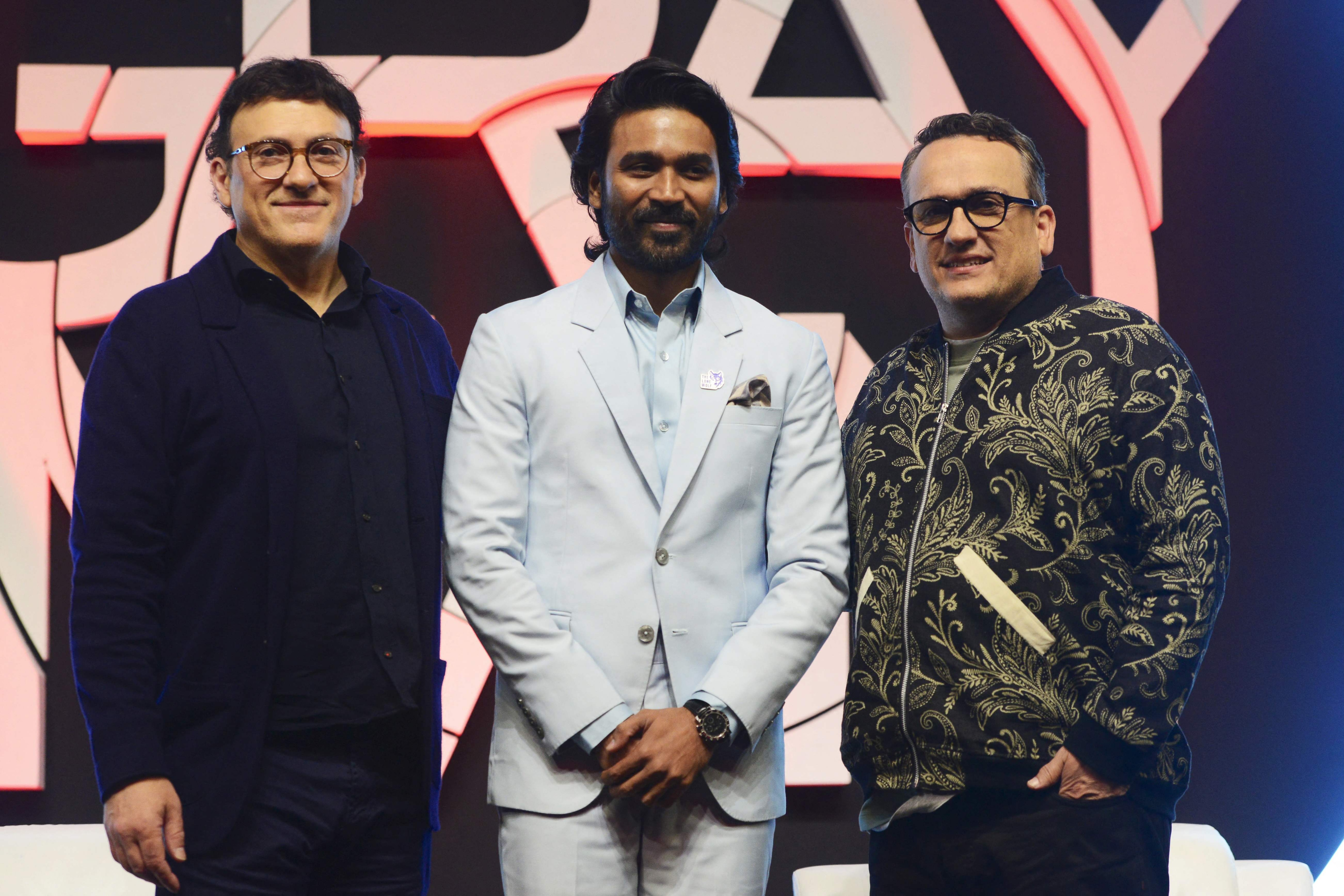 American movie directors and producers Anthony Russo and Joe Russo with Dhanush (centre) during The Gray Man promotions in Mumbai. (AFP) American movie directors and producers Anthony Russo and Joe Russo with Dhanush (centre) during The Gray Man promotions in Mumbai. (AFP)