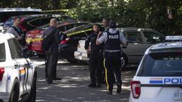 Royal Canadian Mounted Police and Surrey Police officers work at the site where Ripudaman Singh Malik was shot dead in Surrey, British Columbia, Canada, on July 14, 2022. (AP)