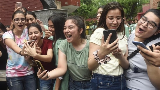 Students overjoyed after checking their scores.