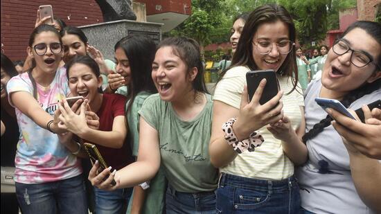 Students celebrate after checking their scores as the Central Board of Secondary Education (CBSE) Class 10 exam results were declared in New Delhi on Friday. (PTI PHOTO.)