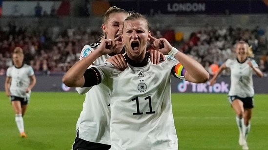 Germany's Alexandra Popp celebrates with Jule Brand, centre left, after scoring her side's second goal during the Women Euro 2022 quarter final soccer match between Germany and Austria at Brentford Community Stadium in London.(AP)