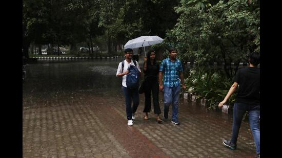 Under my umbrella: Some made new friends courtesy the rain, shared umbrellas and made it to their class on time.