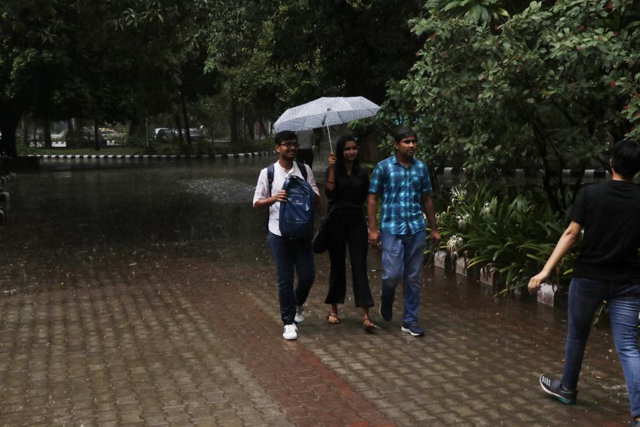 Under my umbrella: Some made new friends courtesy the rain, shared umbrellas and made it to their class on time.