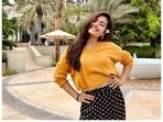 Rashmika Mandanna sets street style goals in mustard yellow crop sweatshirt, floral black pants as she travels to Abu Dhabi for work (Instagram/rashmika_mandanna) Rashmika Mandanna sets street style goals in mustard yellow crop sweatshirt, floral black pants as she travels to Abu Dhabi for work (Instagram/rashmika_mandanna)