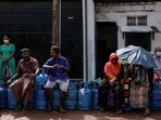 People wait in a line to buy domestic gas tanks near a distributor, amid the country's economic crisis, in Colombo.