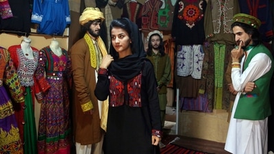 FILE - Ajmal Haqiqi, right, watches as Mahal Wak, center, practices modeling, in Kabul, Afghanistan, Aug. 3, 2017. The Taliban have detained a famous Afghan fashion model along with three colleagues, including Haqiqi, accusing them of disrespecting Islam and the Holy Quran. (AP) FILE - Ajmal Haqiqi, right, watches as Mahal Wak, center, practices modeling, in Kabul, Afghanistan, Aug. 3, 2017. The Taliban have detained a famous Afghan fashion model along with three colleagues, including Haqiqi, accusing them of disrespecting Islam and the Holy Quran. (AP)