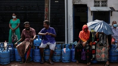 People wait in a line to buy domestic gas tanks near a distributor, amid the country's economic crisis, in Colombo. (Reuters)