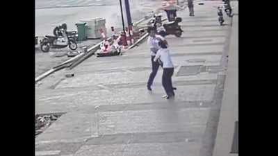 Taken from the viral Twitter video, the image shows the man saving the toddler in China. (Twitter/@zlj517)