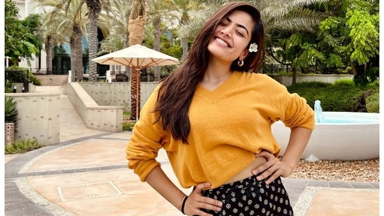 Rashmika Mandanna sets street style goals in mustard yellow crop sweatshirt, floral black pants as she travels to Abu Dhabi for work&nbsp;(Instagram/rashmika_mandanna)
