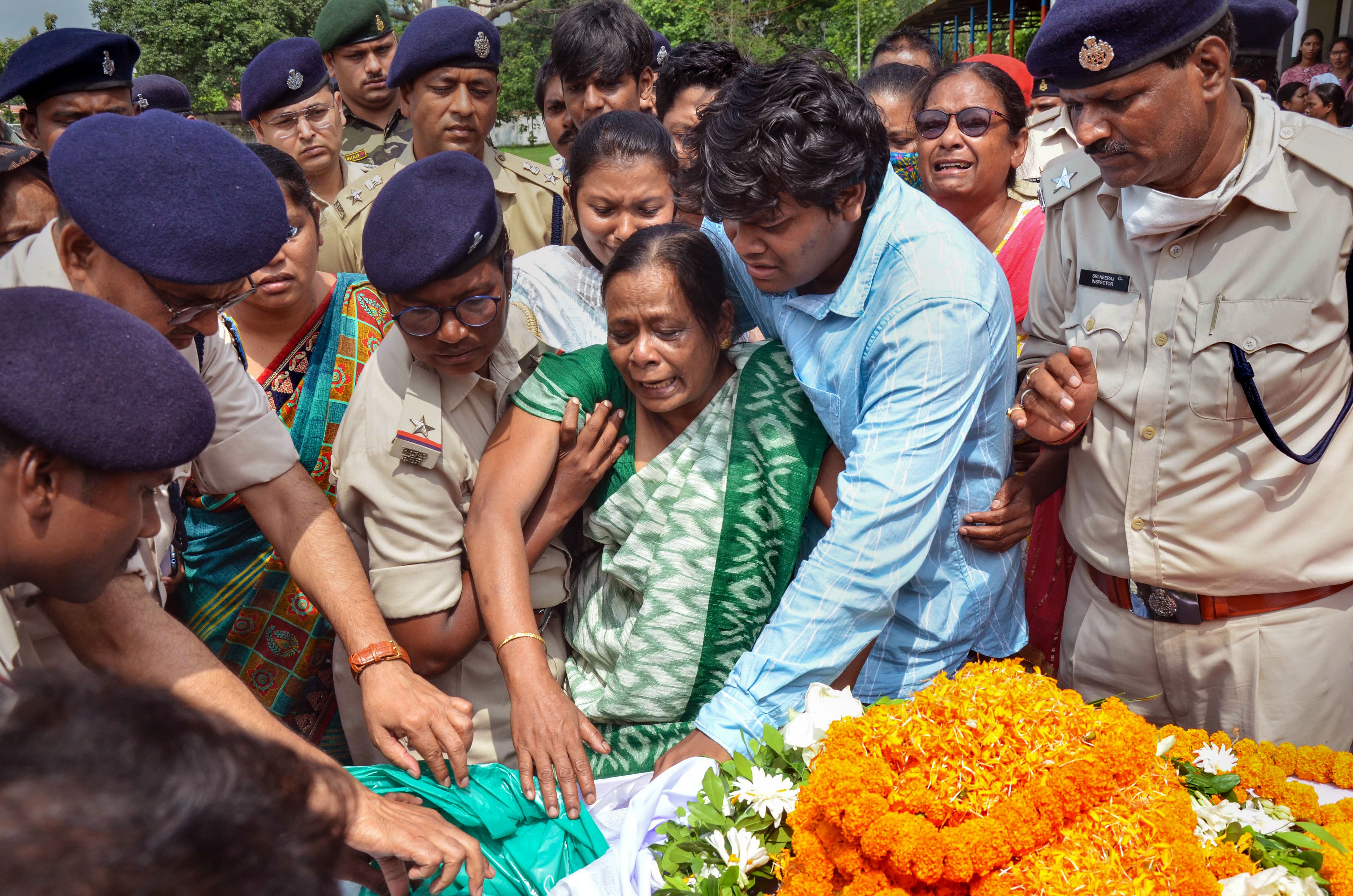 Family members of female sub inspector Sandhya Topno break down near her mortal remains, at New Police Line in Ranchi, Wednesday, July 20, 2022. (PTI Photo) Family members of female sub inspector Sandhya Topno break down near her mortal remains, at New Police Line in Ranchi, Wednesday, July 20, 2022. (PTI Photo)