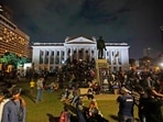 Protesters sit and walk around after storming in at the Sri Lankan president's office, in Colombo, Sri Lanka.
