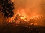 A structure burns on Jerseydale road during the Oak Fire in Mariposa County, California, US. A structure burns on Jerseydale road during the Oak Fire in Mariposa County, California, US.