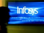 A man walks past a billboard of Infosys Technologies Ltd's office in Bangalore.