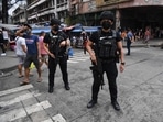 Members of police Special Weapons and Tactics (SWAT) stand guard along a popular market street in Manila.(AFP) Members of police Special Weapons and Tactics (SWAT) stand guard along a popular market street in Manila.(AFP)