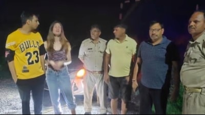 The Ukrainian woman and her Indian husband with the cops who rescued them. (Sourced)