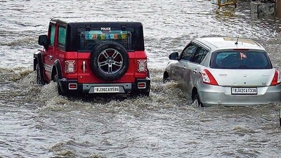 Vehicles wade through a flooded road following monsoon rains in Ajmer, Sunday. (PTI) Vehicles wade through a flooded road following monsoon rains in Ajmer, Sunday. (PTI)