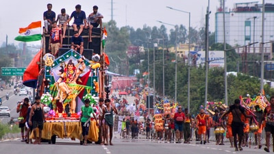 Kanwariyas (Lord Shiva devotees) pull a chariot of Lord Shiva as they return from Haridwar after collecting holy water from the Ganga river, during the holy month of 'Saavan', in Meerut. (PTI)