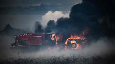 Firefighter trucks burning during a wildfire on the Mont d'Arrees, outside Brasparts, western France.&nbsp; (AFP)
