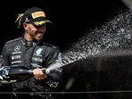 Second placed Mercedes' British driver Lewis Hamilton celebrates with champagne on the podium of the French Formula One Grand Prix.(AFP)