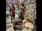 The image shows the Northern Army Commander Lt Gen Upendra Dwivedi commending the army dog named Holi. The image shows the Northern Army Commander Lt Gen Upendra Dwivedi commending the army dog named Holi. 