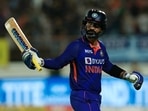 Dinesh Karthik raises his bat after scoring a fifty for India.&nbsp;