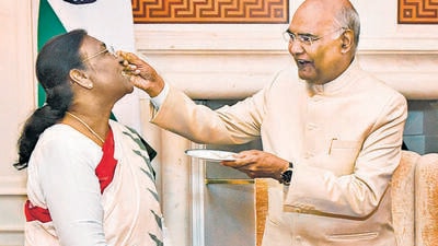 Former president Ram Nath Kovind offers sweets to his successor Droupadi Murmu, before her swearing-in-ceremonyat Rashtrapati Bhavan in New Delhi on Monday. (PTI) Former president Ram Nath Kovind offers sweets to his successor Droupadi Murmu, before her swearing-in-ceremonyat Rashtrapati Bhavan in New Delhi on Monday. (PTI)