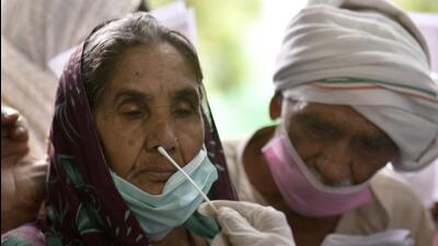 A healthcare worker collects a swab sample for a Covid-19 test at a district hospital on Monday. (HT PHOTO.)