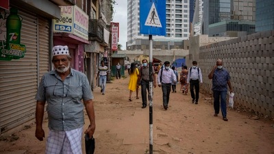 People walk to work in the morning amid fuel shortage in Colombo. (AP)