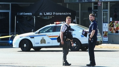 Police officers stand near a crime scene after authorities alerted residents of multiple shootings targeting transient victims in the Vancouver suburb of Langley, British Columbia, Canada. (REUTERS)