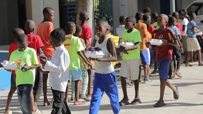 Haitian children who escaped violence in the town of Cite-Soleil line up to receive food while they take refuge at a school, in Port-au-Prince, Haiti, July 22, 2022.&nbsp; (REUTERS)