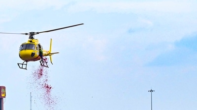 A helicopter is used to shower flower petals on Kanwariyas.&nbsp; (PTI)