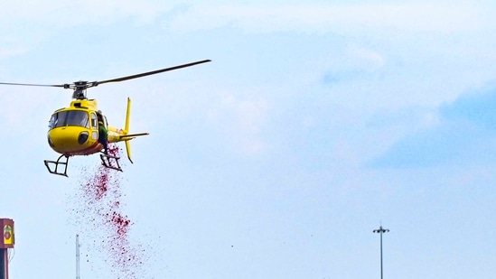 A helicopter is used to shower flower petals on Kanwariyas.&nbsp;(PTI)