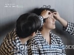 BTS' V laughs as Choi Woo-shik checks his eyes.