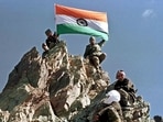 Indian Army hoist national flag from a peak in Drass after it was recaptured during the first week of July 1999.